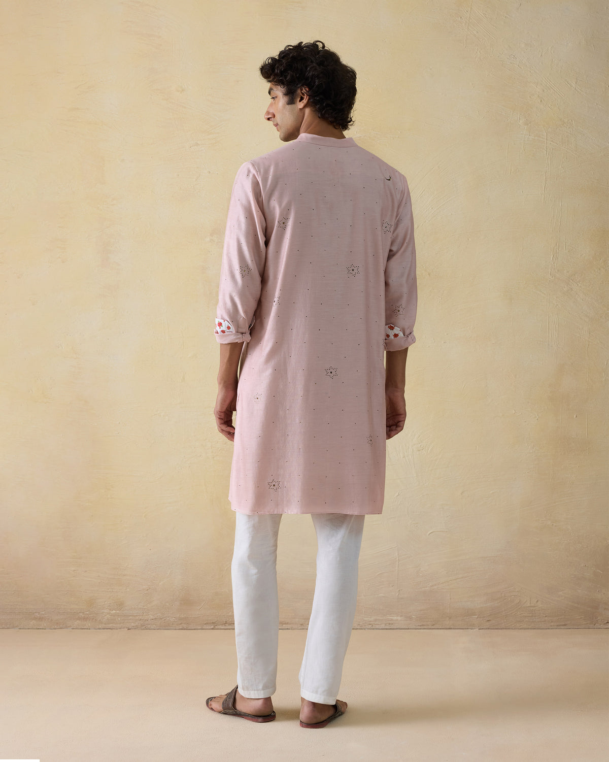 Back of a light pink Arham kurta with mukaish stars.