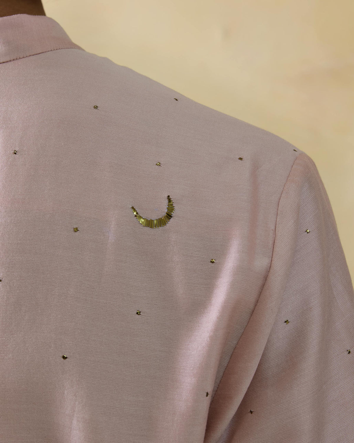Close-up of a light pink Arham kurta showing a mukaish moon on the back.