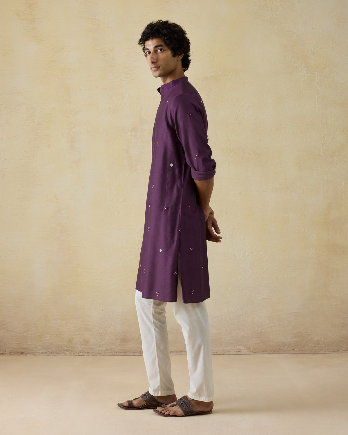 Side view of a jamun pink Neckband Kurta with scattered embroidery.