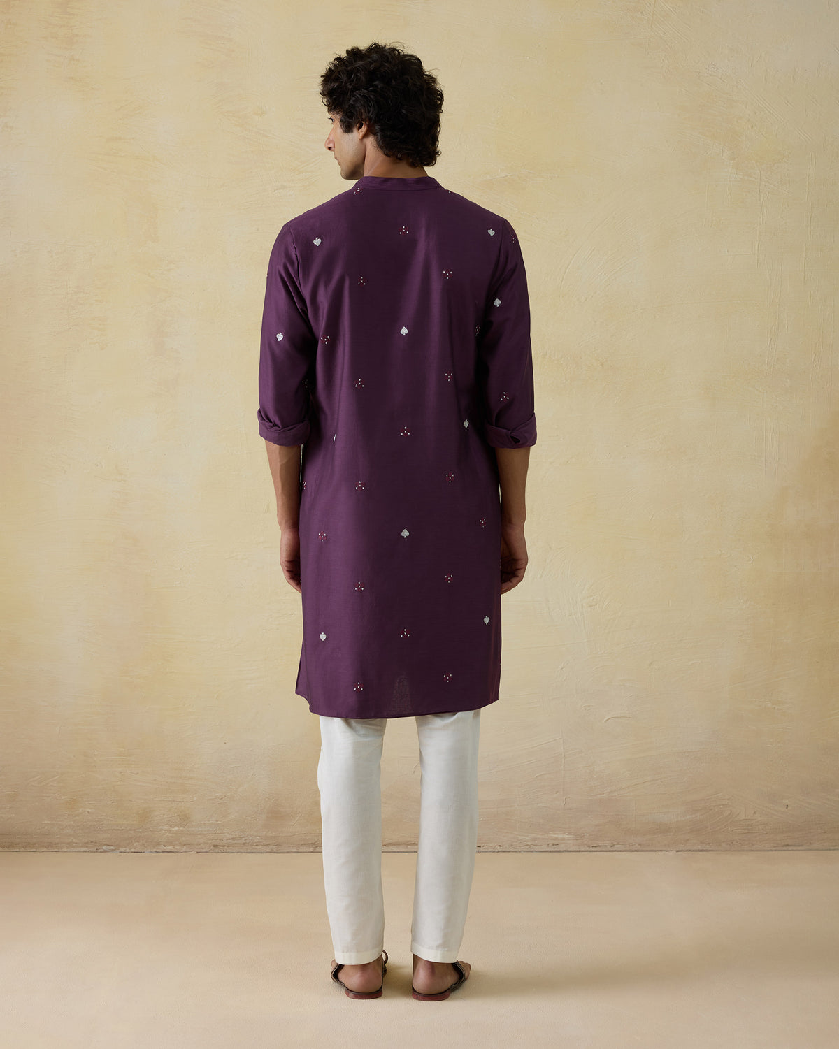 Back of a jamun pink Neckband Kurta with scattered silver embroidery.