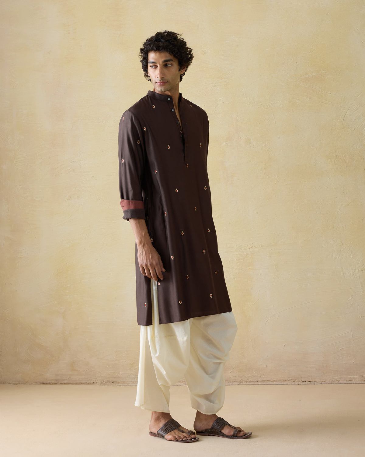 Dark brown embroidered neckband kurta worn at a three-quarter angle.