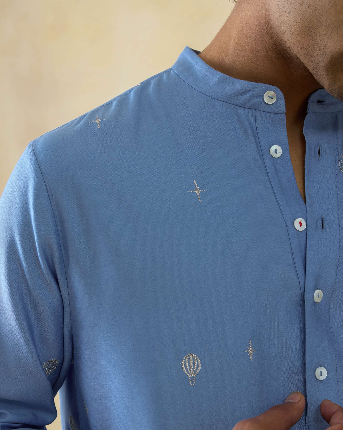 Close-up of light blue Bageecha kurta with hot air balloon embroidery.