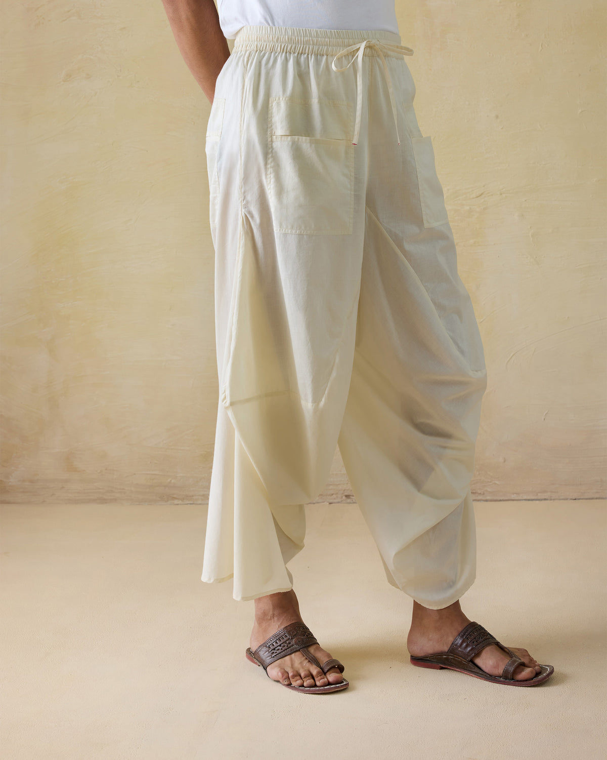 Ivory Tahir pants with a drawstring waist and voluminous drape.