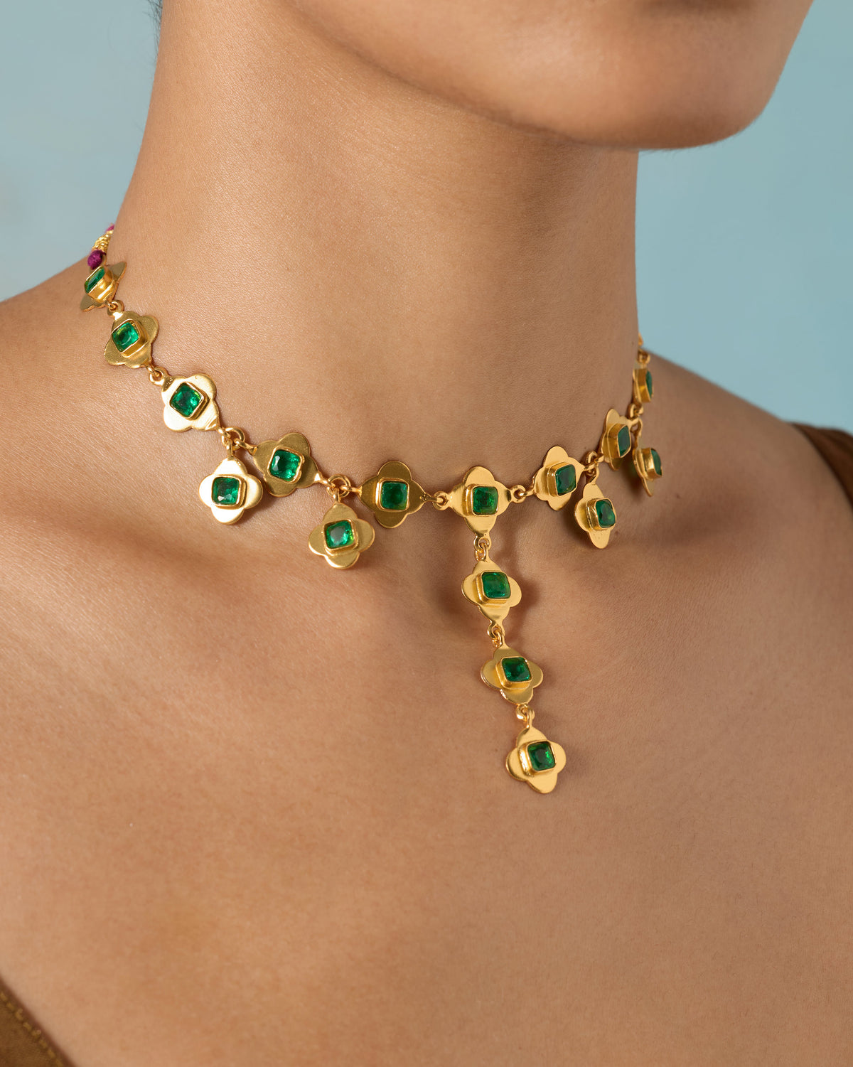 Gold Clover necklace with green glass links and a center drop.