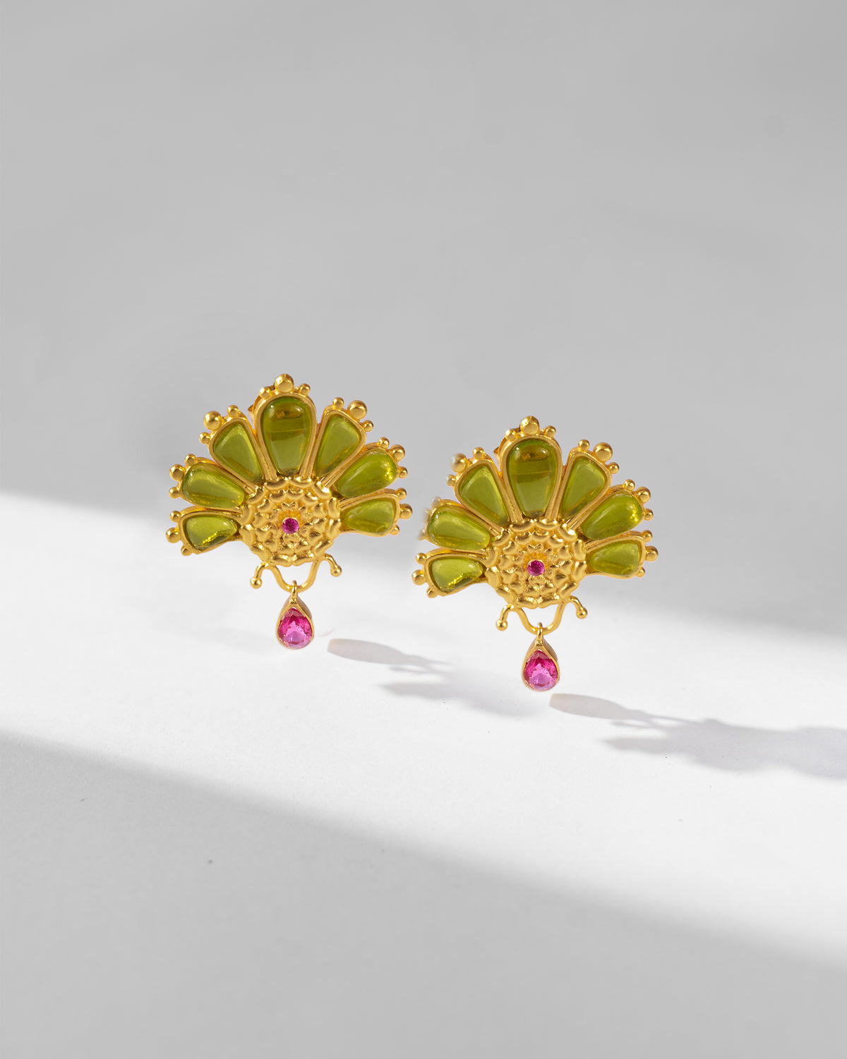 Close-up of Mari-Palm earrings showing the green petals and pink drops.