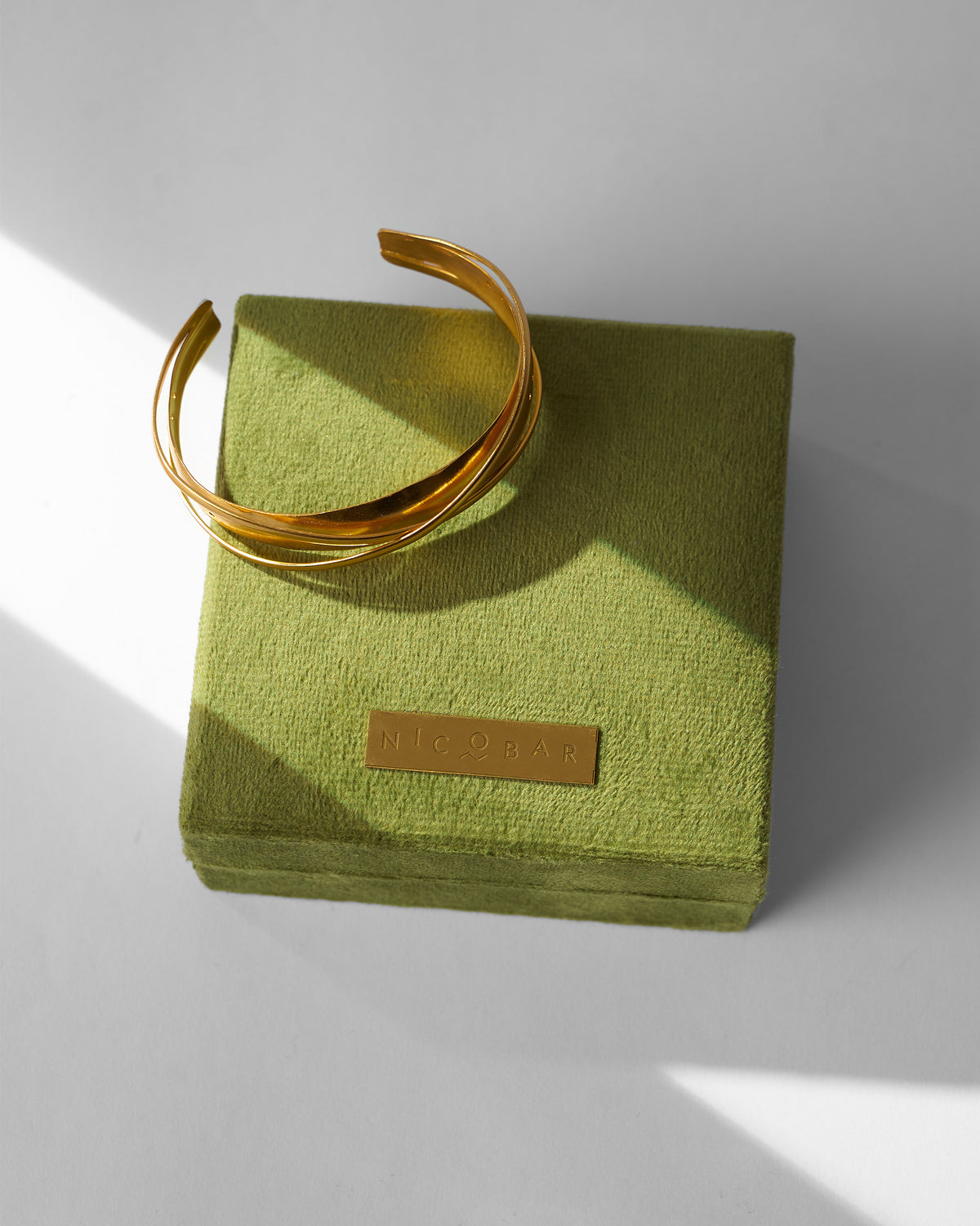 Kaveri Bangle resting on a green velvet box.