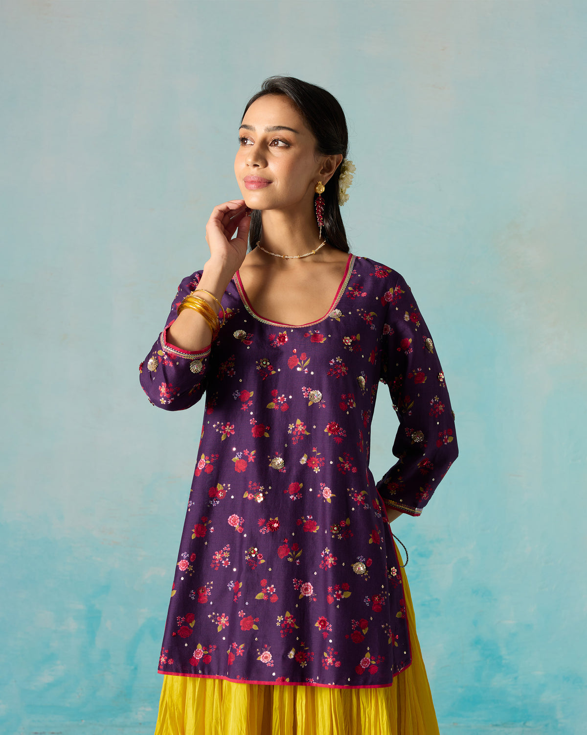 Three-quarter view of a purple Sehra kurti worn by a person.