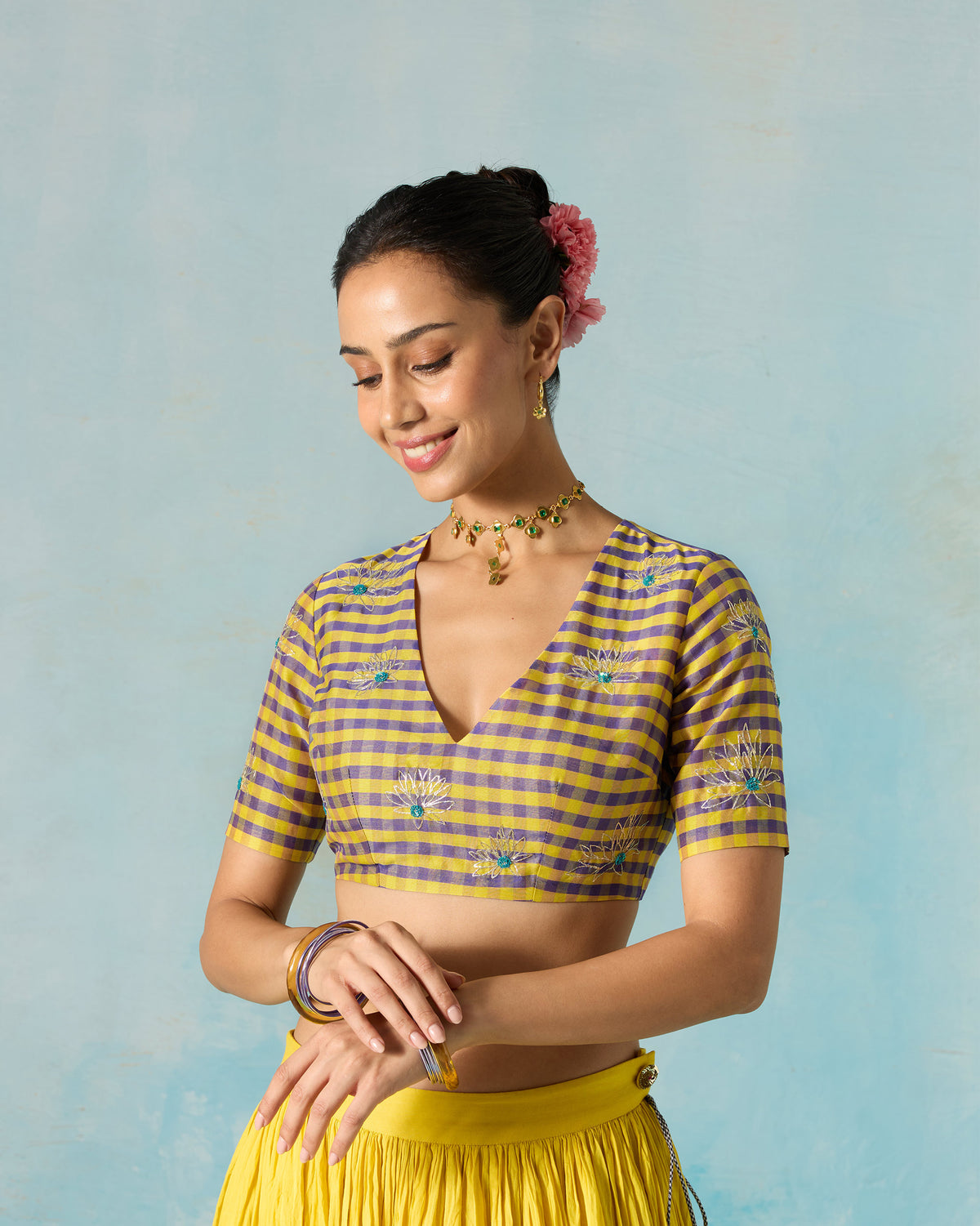 Front view of a Dori blouse worn by a person, with a deep V neckline.