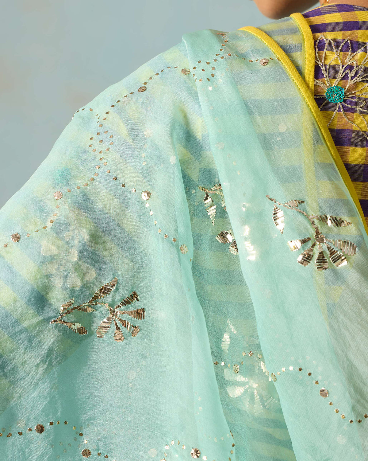 Close-up of a sheer sea foam Adaa Dupatta with silver floral mukaish.