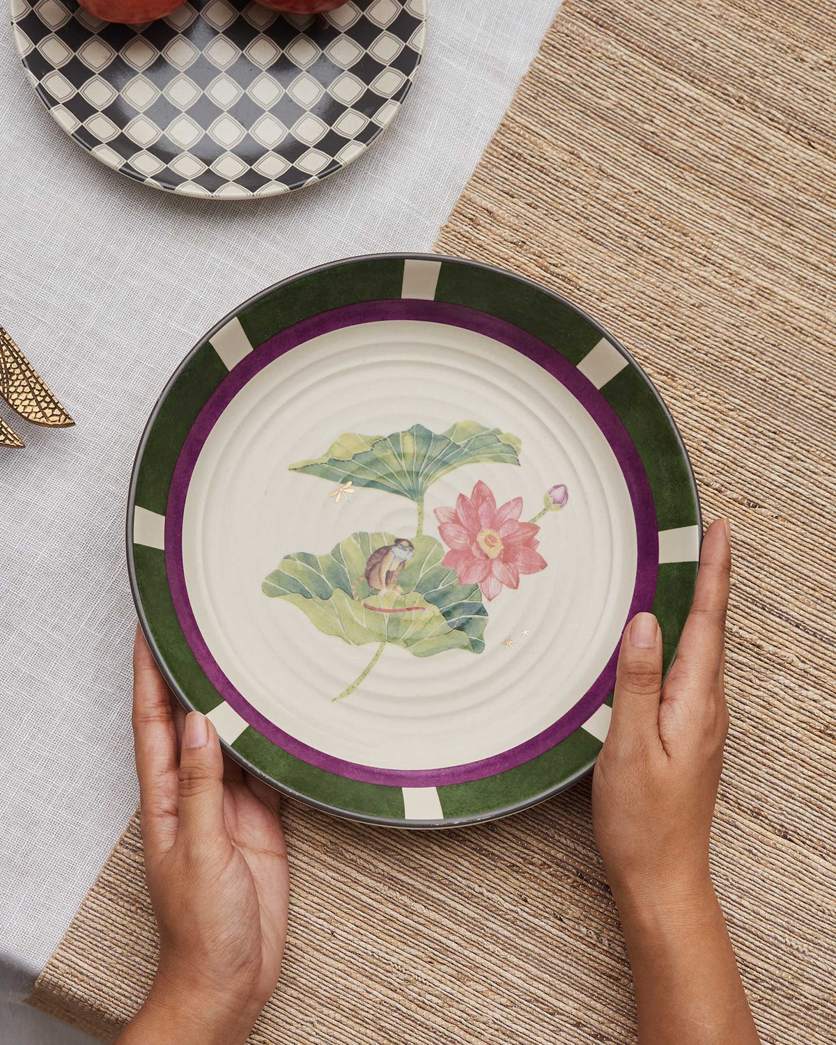 Lotus Garden pasta plate with pink lotus, monkey, and green border.