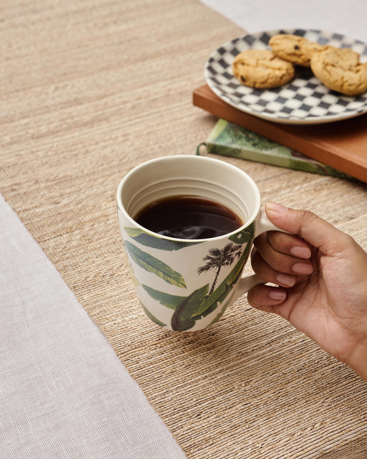 Person holding the Galle Mug filled with coffee.