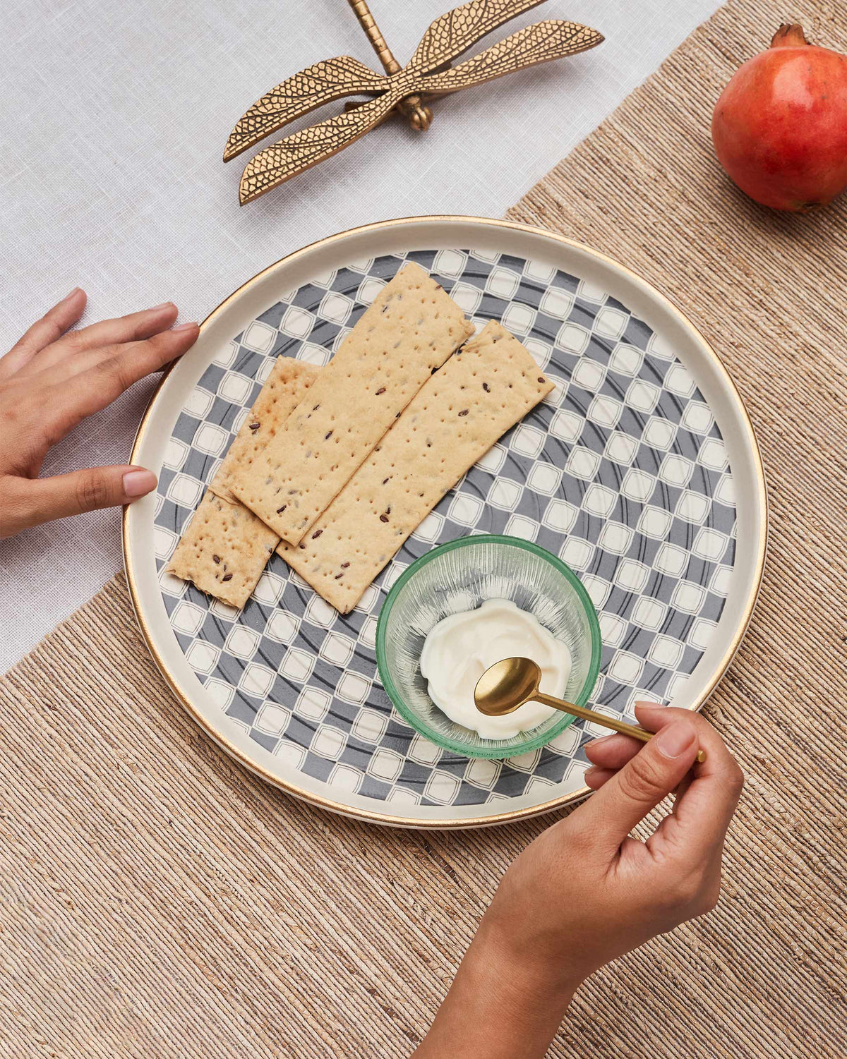 Fez chip and dip platter with green glass bowl and crackers on a woven mat.