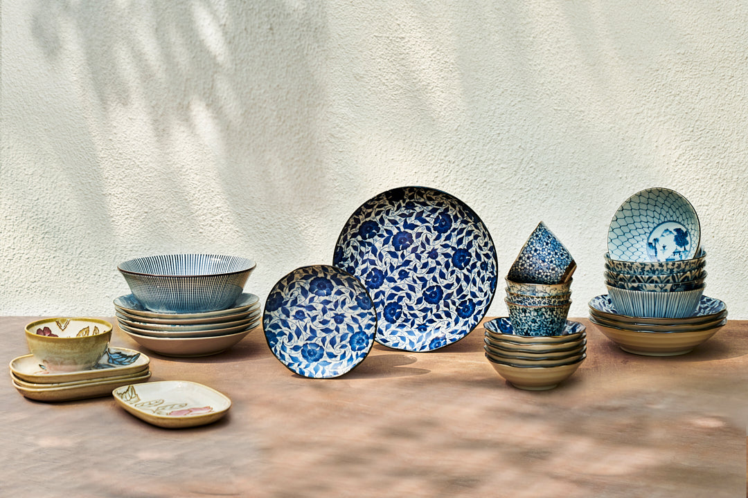 Ocha tea cups shown among blue and white plates and bowls.