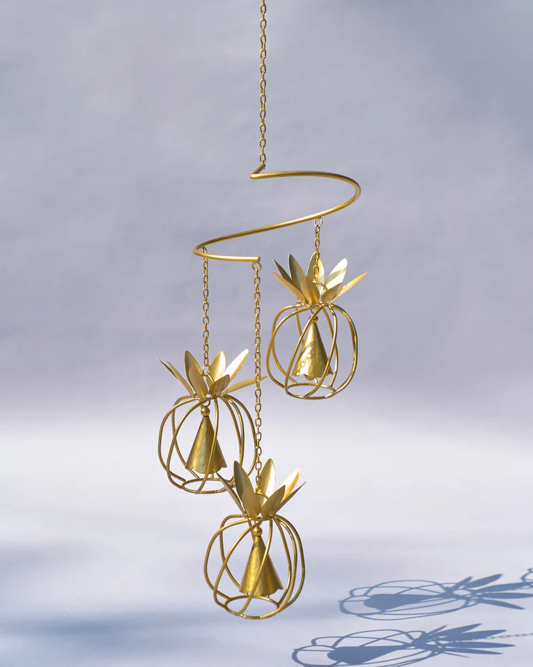 Gold pineapple wind chime with three tiered wireframe pineapple bells.