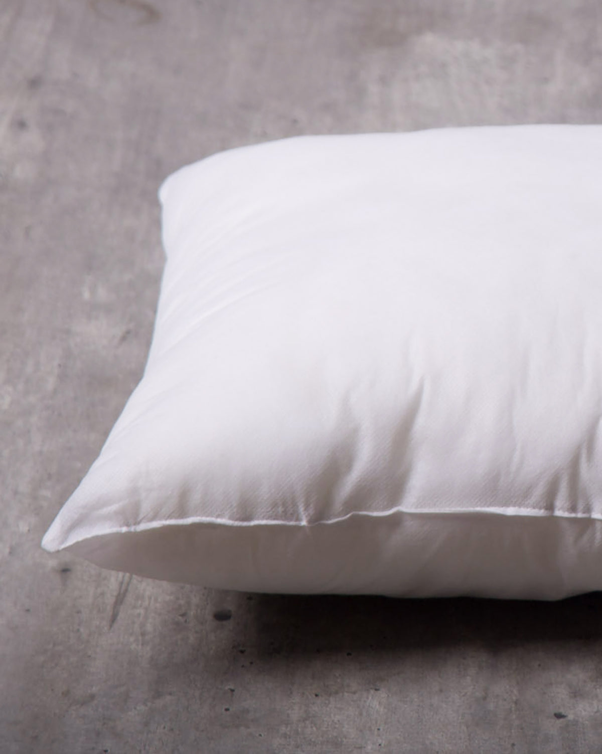 Close-up of a 46 x 46 cm cushion filler showing its plump edge.