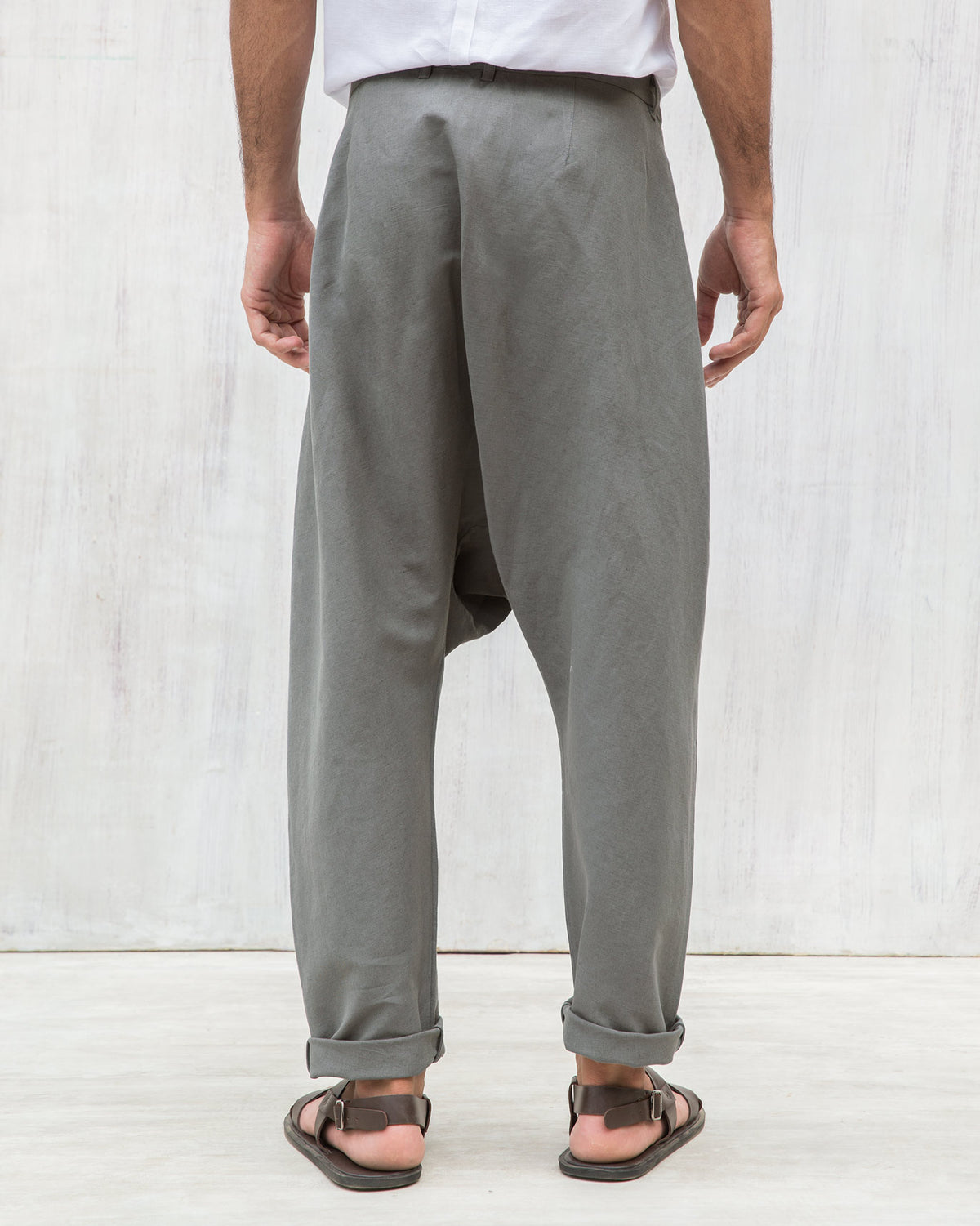 Back of Slouchy Pants with turned-up cuffs worn by a person.