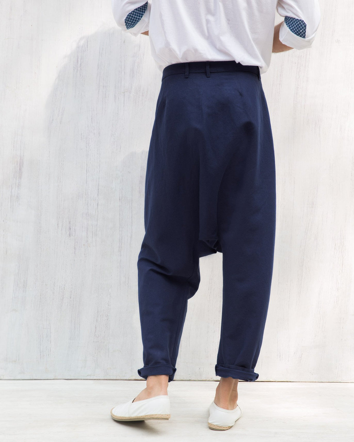 Back of blue Slouchy pants with a drop-crotch silhouette.