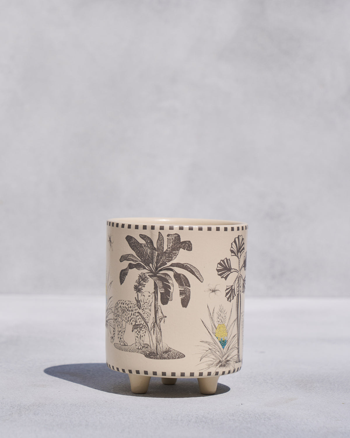 Sher Planter with palm tree and leopard motifs, standing on four feet.