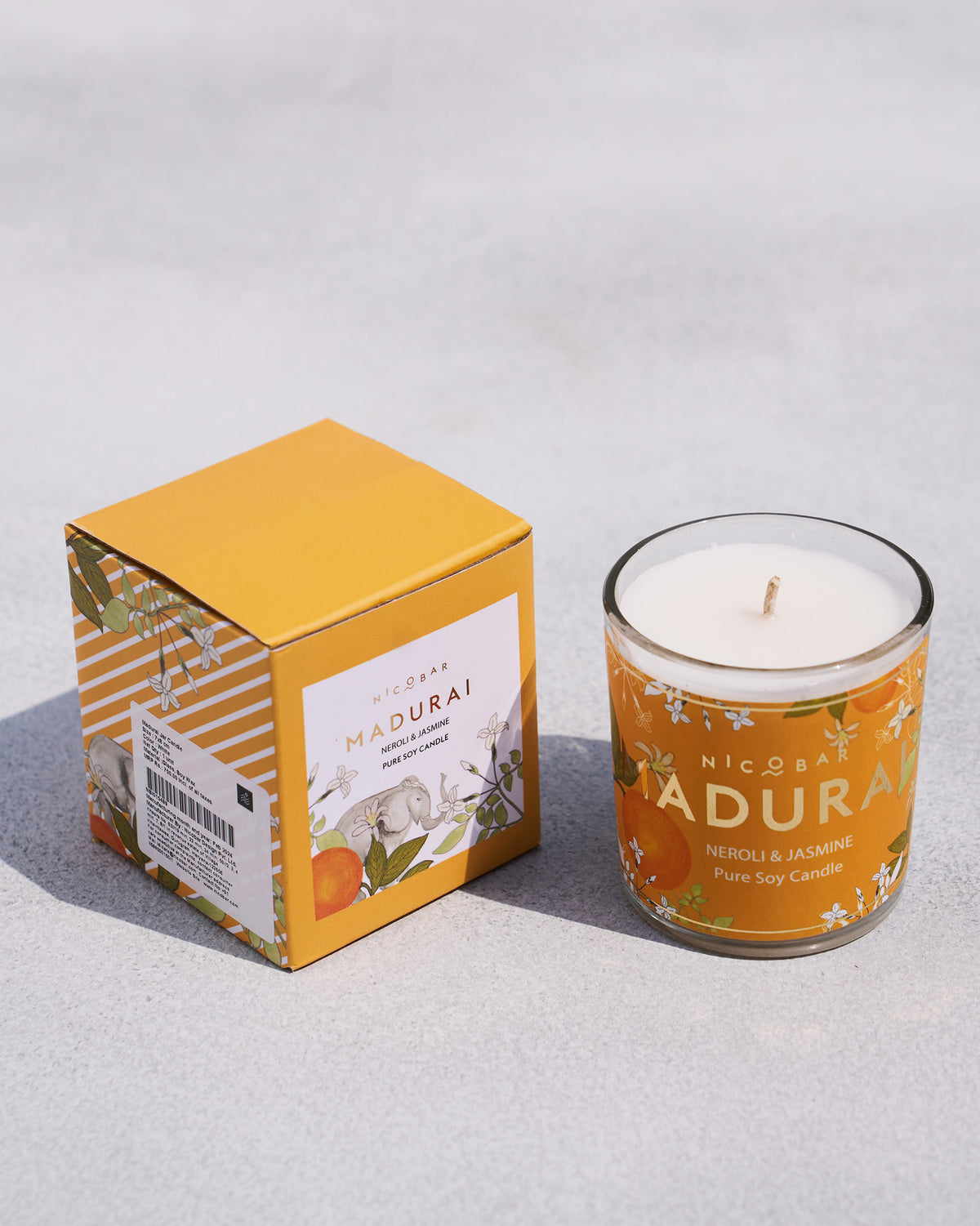 Madurai jar candle beside its mustard box.