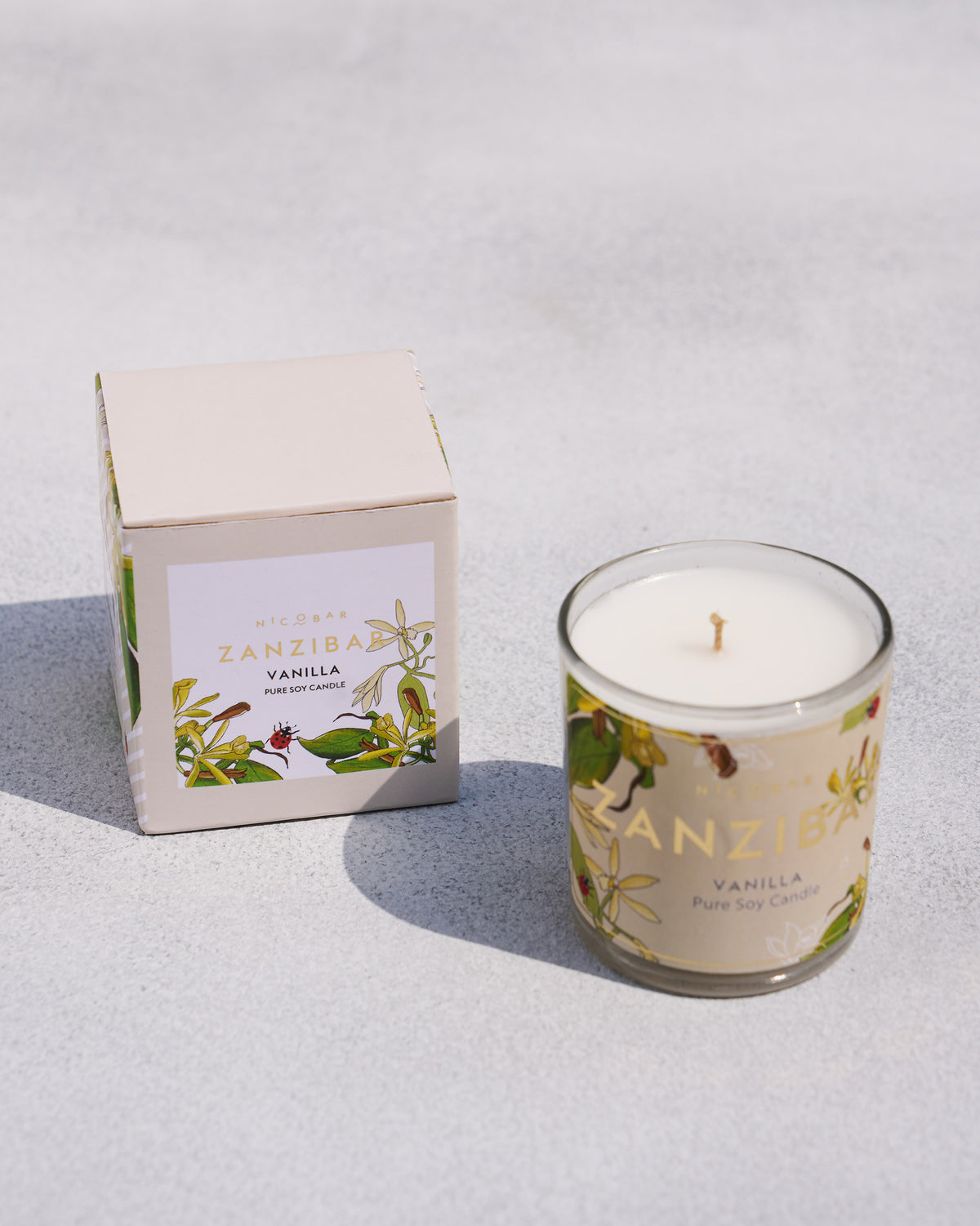 Zanzibar Jar Candle beside its cream box, showing the vanilla label.