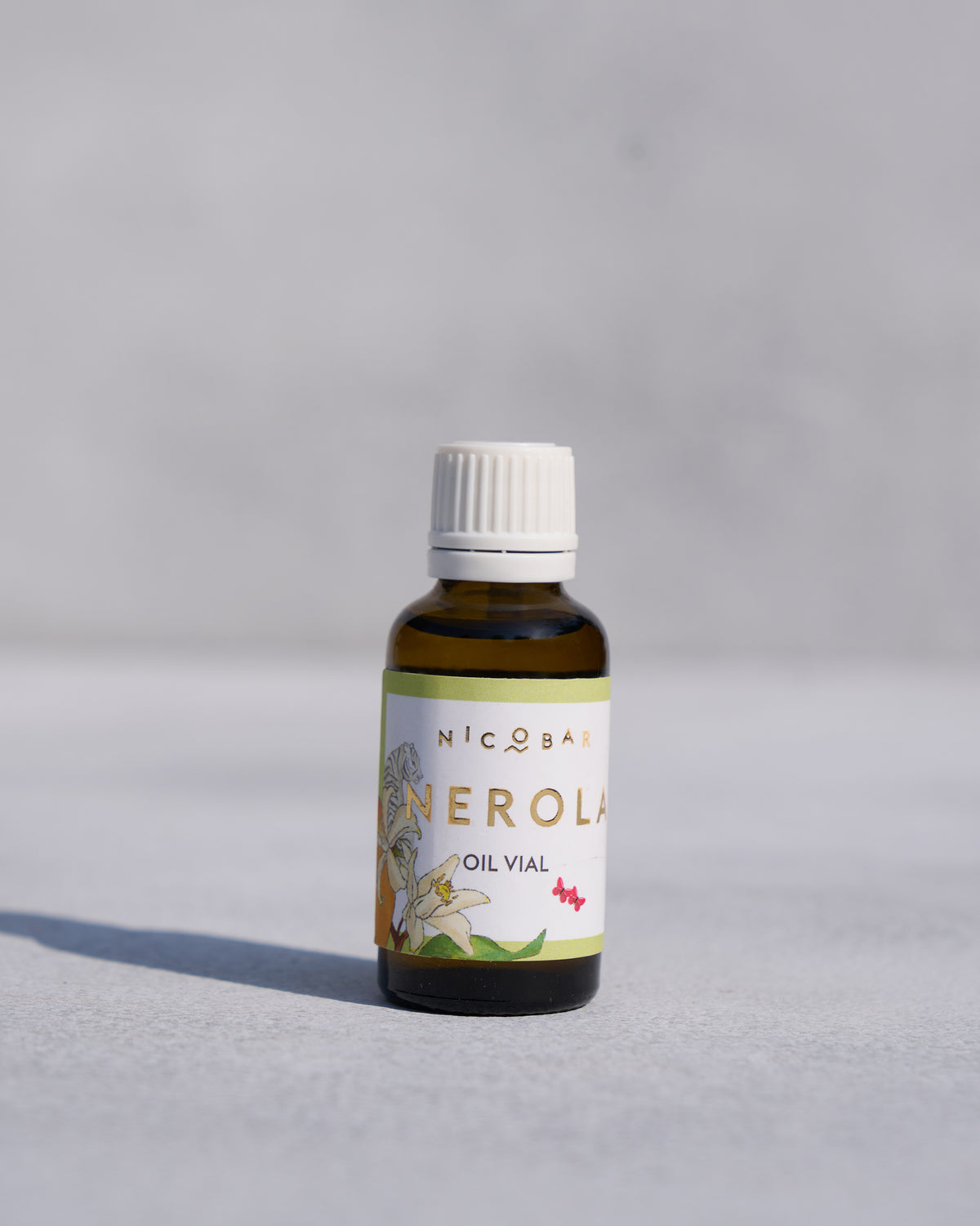 NEROLA fragrance vial with a white dropper cap and amber glass.