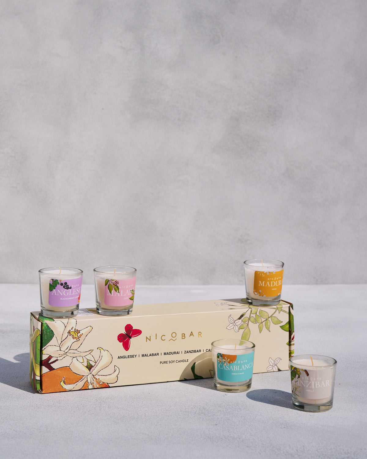 Jar Candles Set of 5 with a Nicobar box and five labelled glass votives.