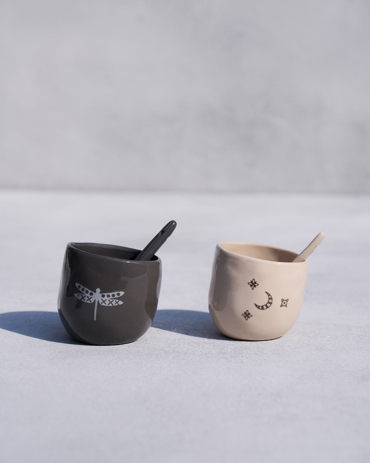 Taramandal salt and pepper pots with dragonfly and moon motifs.