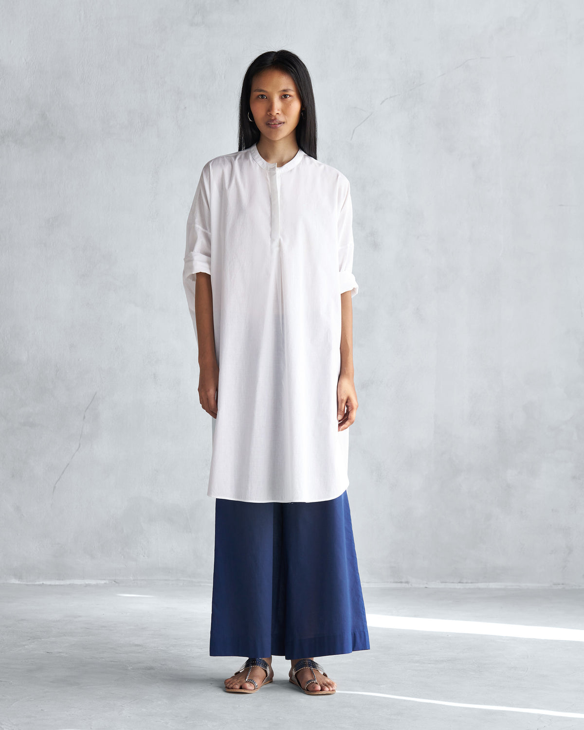 Person wearing a white Lazy Sunday tunic with a mandarin collar.