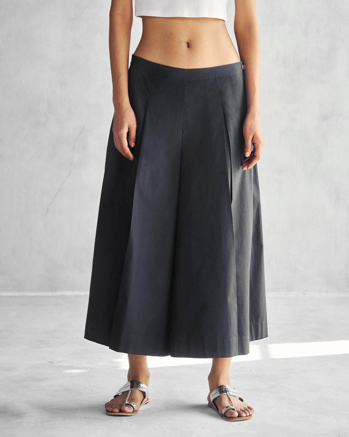 Person wearing black Pleated Flare Culottes.