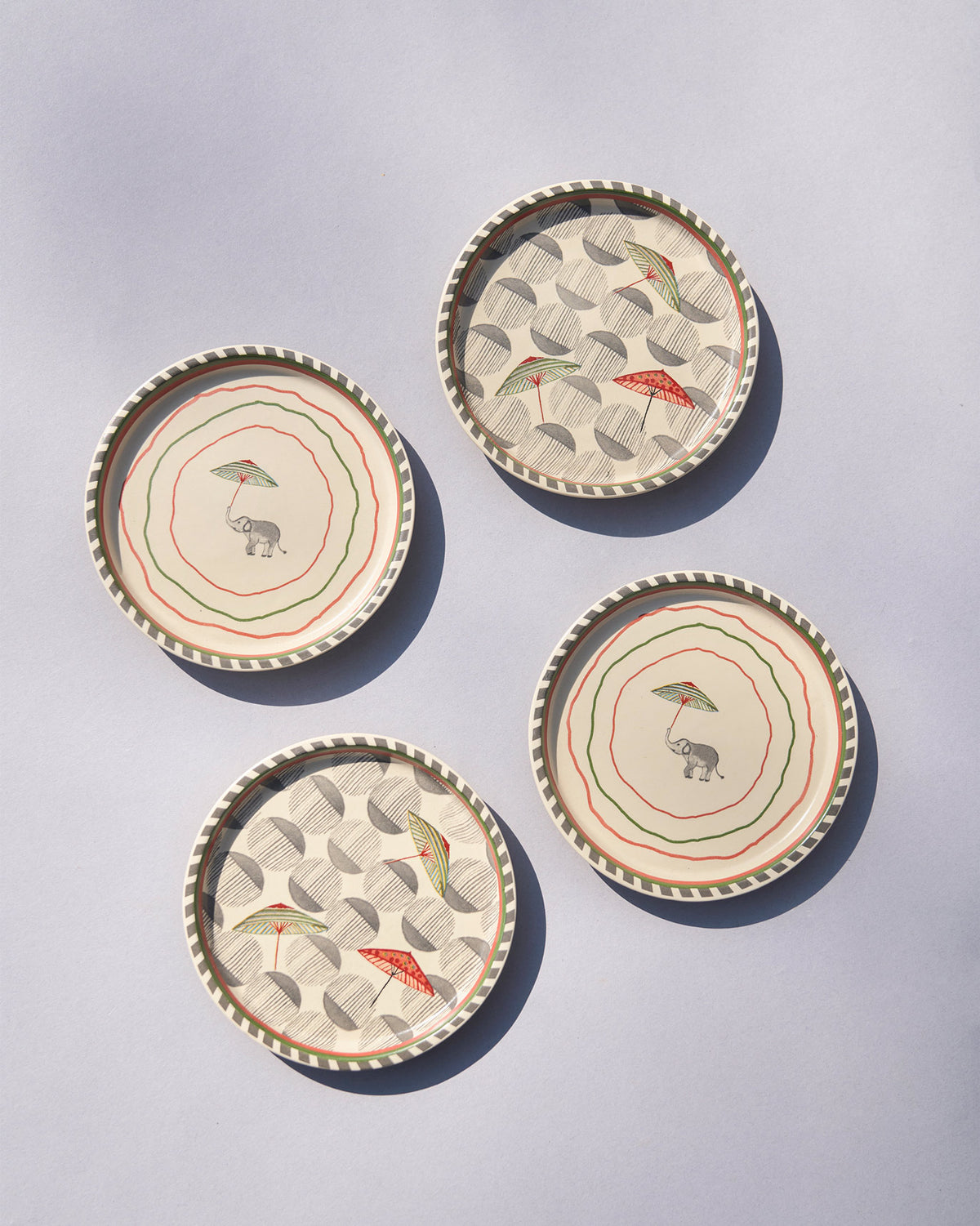 Set of four Tribe Coasters with elephant and umbrella motifs.