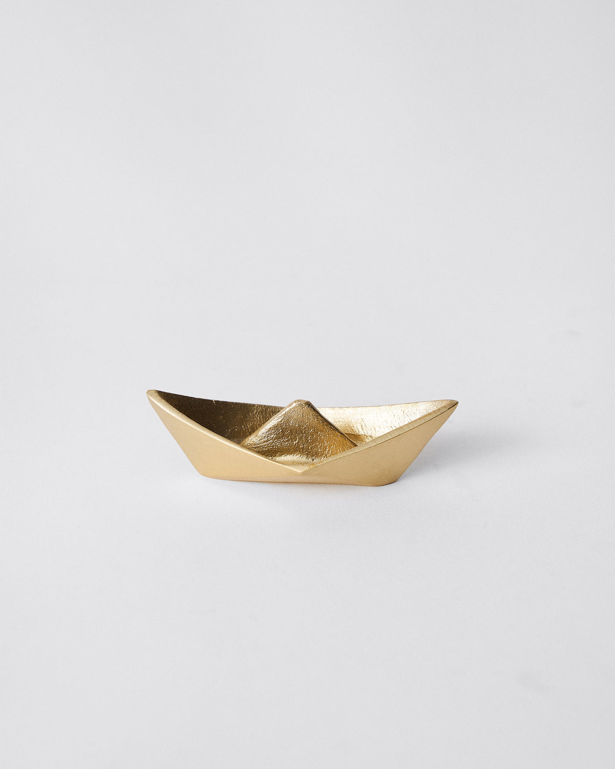 Boat Origami dish in gold, shaped like a folded paper boat.
