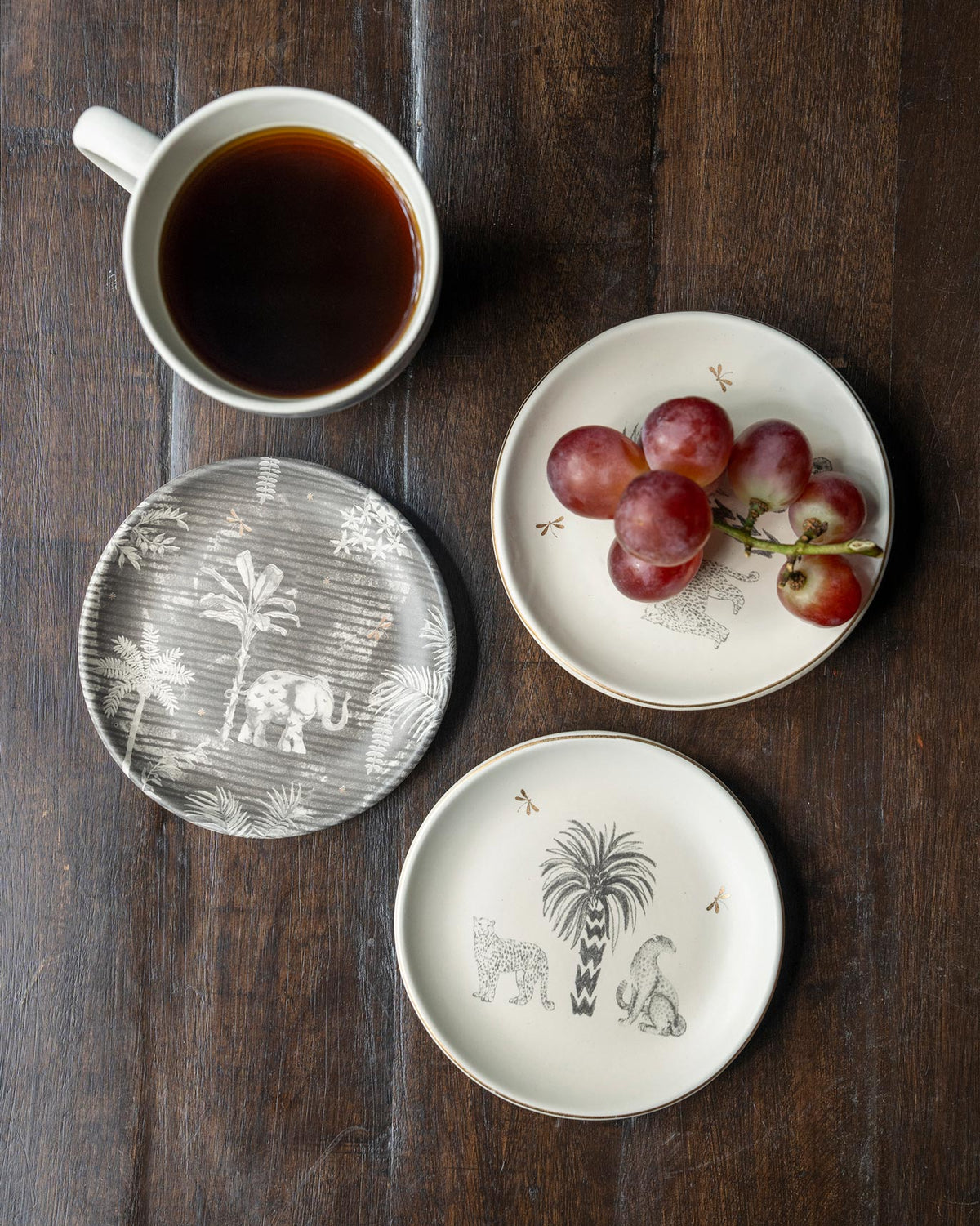 Periyar Tea Plates seen from above, with palm and leopard designs.