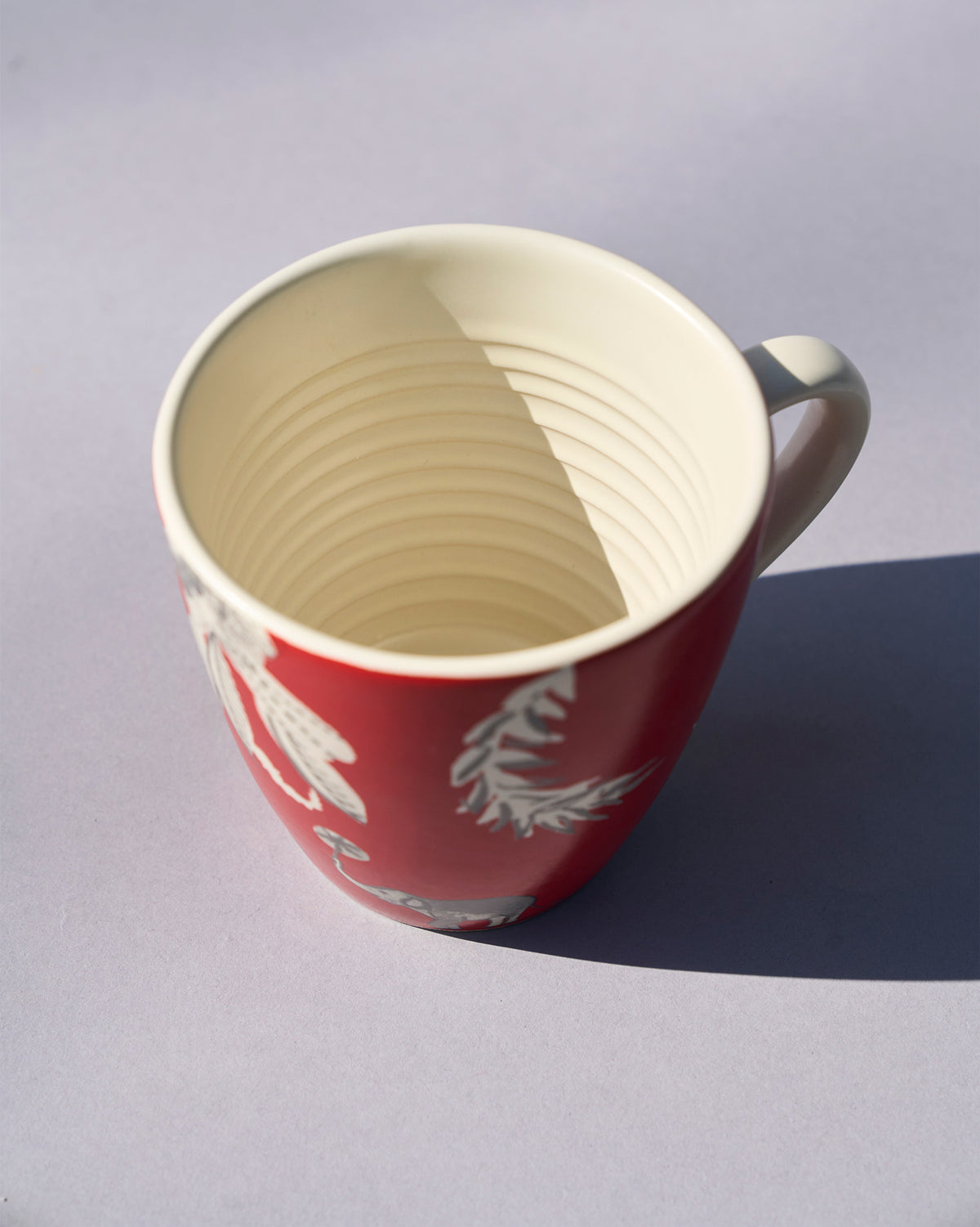 Red Thazin conical mug seen from above, with a ridged inner glaze.