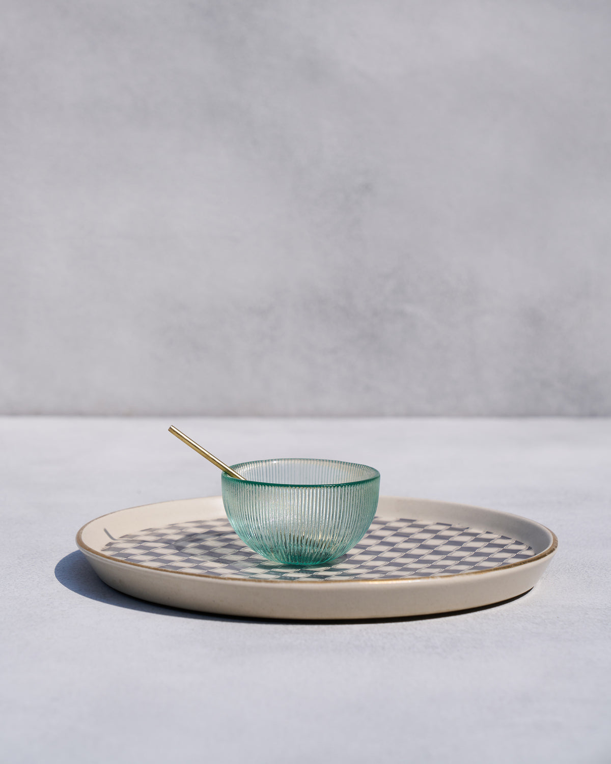 Fez chip and dip platter with gold rim holding a green glass bowl and spoon.