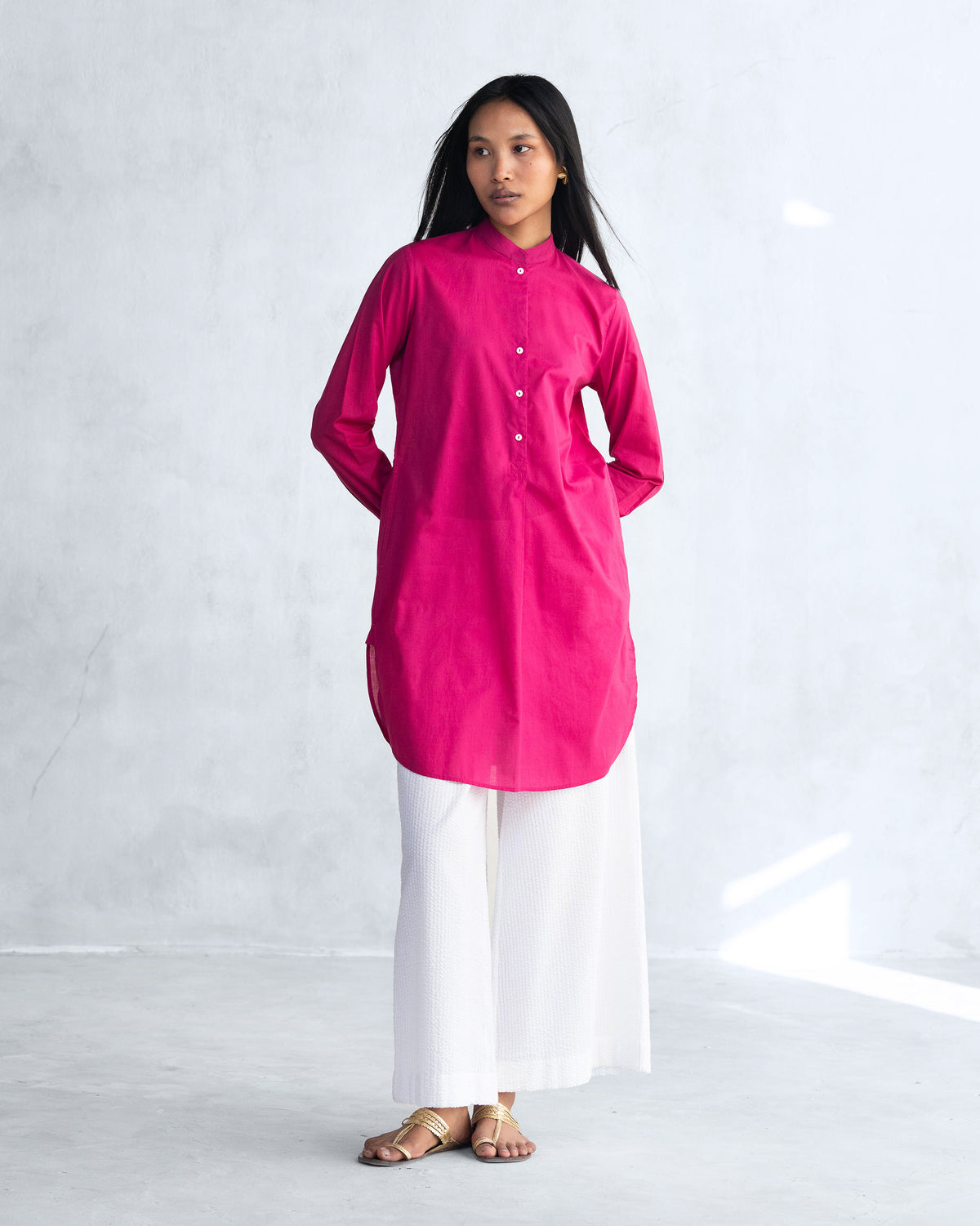 Full-length view of the Basic Mid Length Kurta in berry with a curved hem.