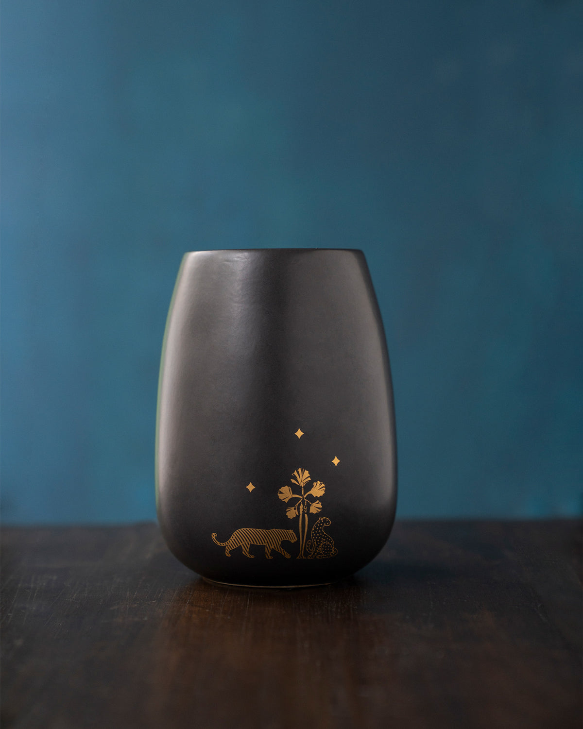 Back of the Sher diffuser with a gold tiger, leopard and palm.