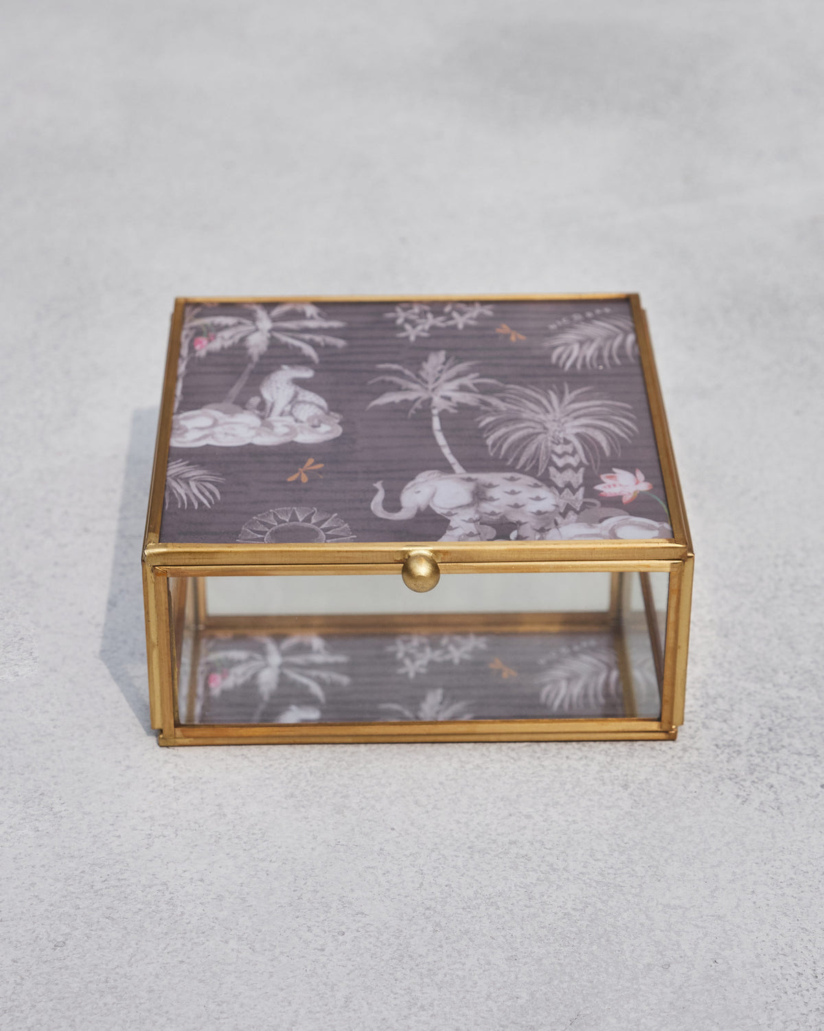 Periyar jewellery box with a brass frame and palm and elephant print on the lid.