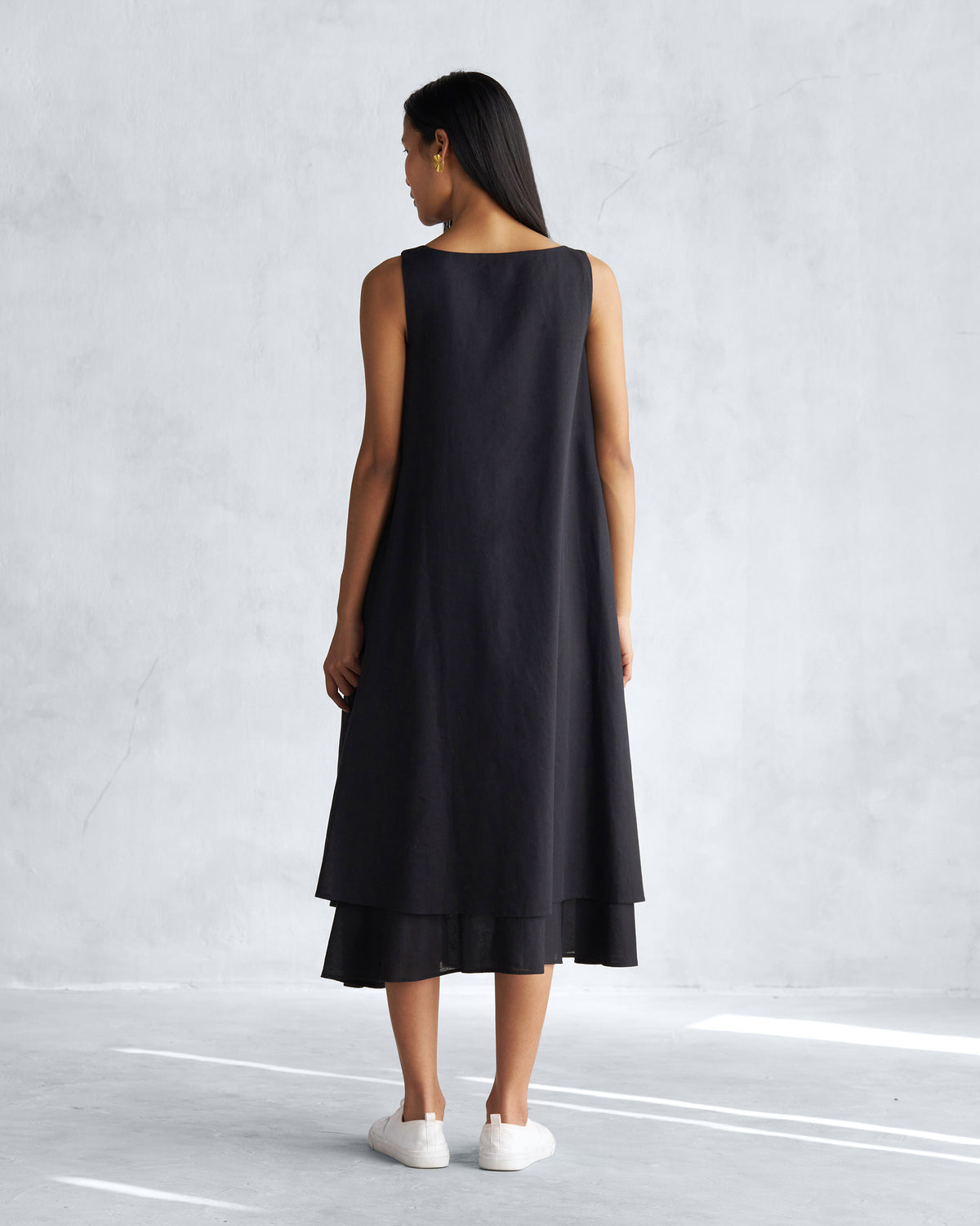 Back of a sleeveless black Double layer dress worn by a person.