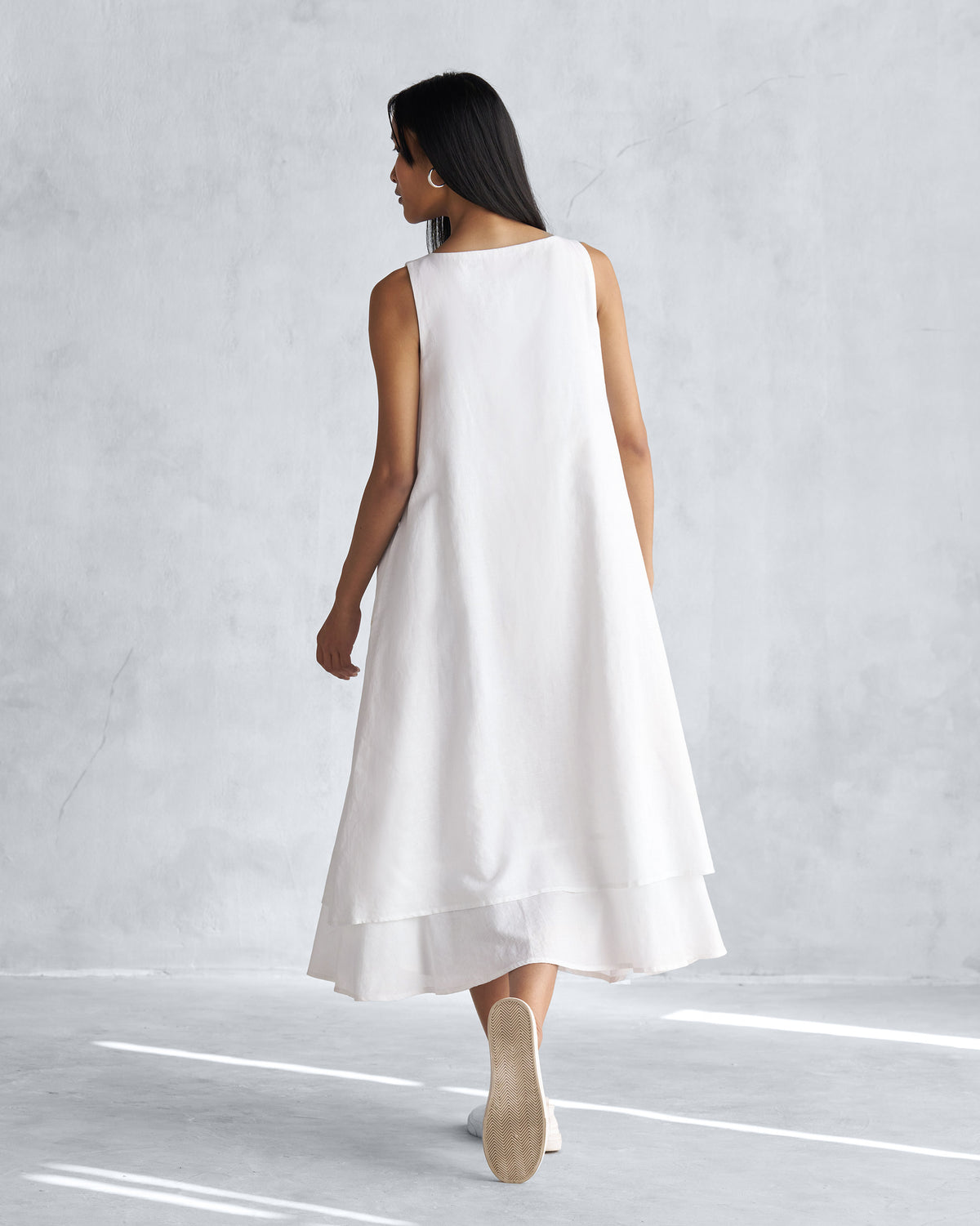 Back of a white Double layer dress worn by a person.