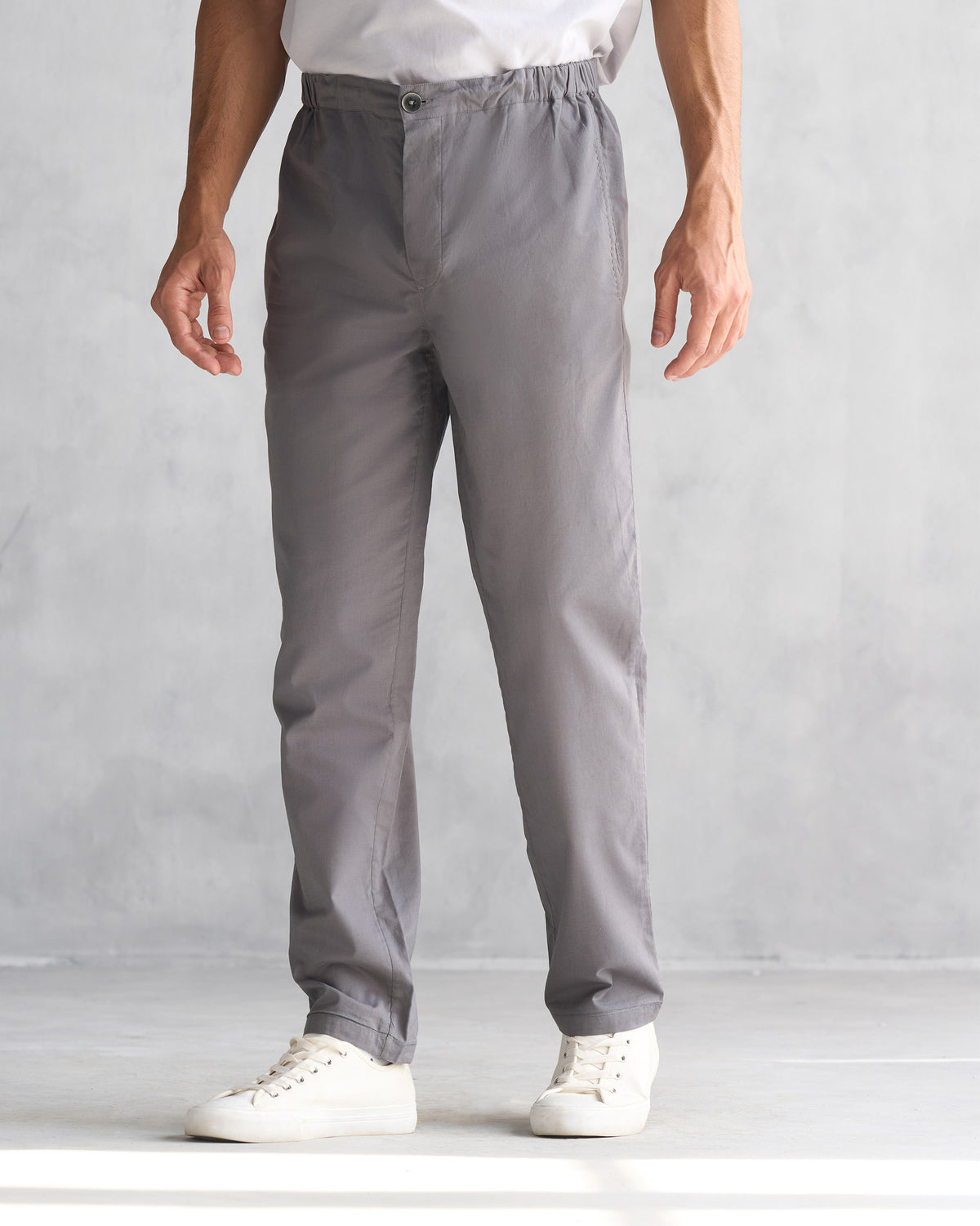 Person wearing charcoal Shillong jammies with a gathered side waist.