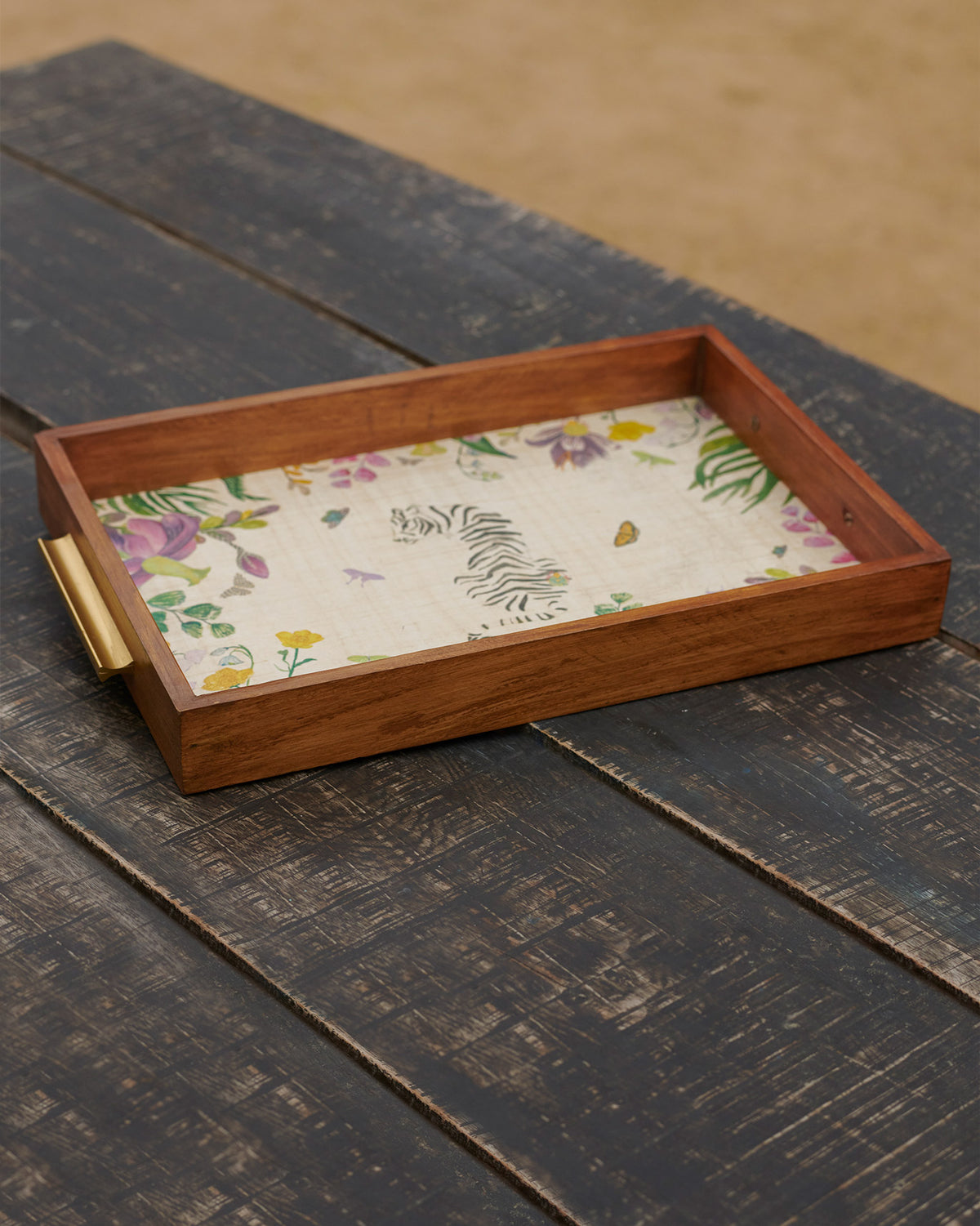 Waadi Rectangle Tray with brass handles and a floral and tiger print.