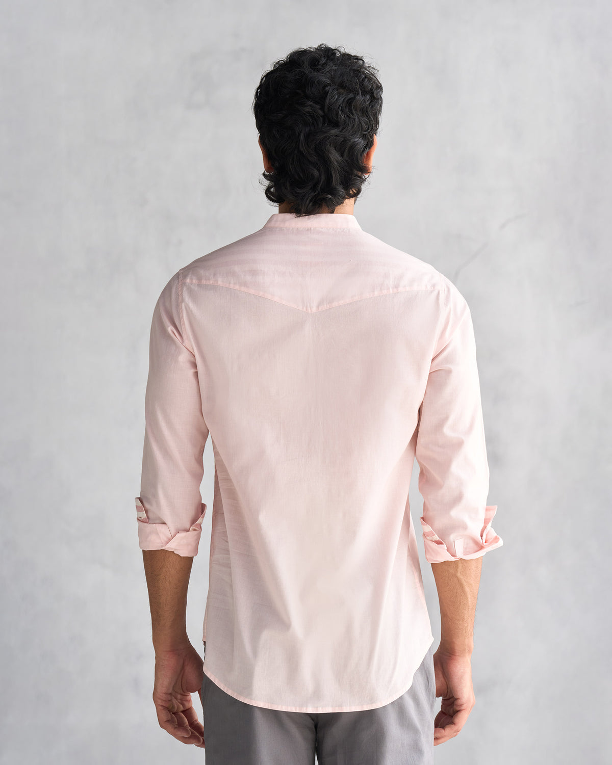 Back of a pink Pondicherry shirt worn by a person.