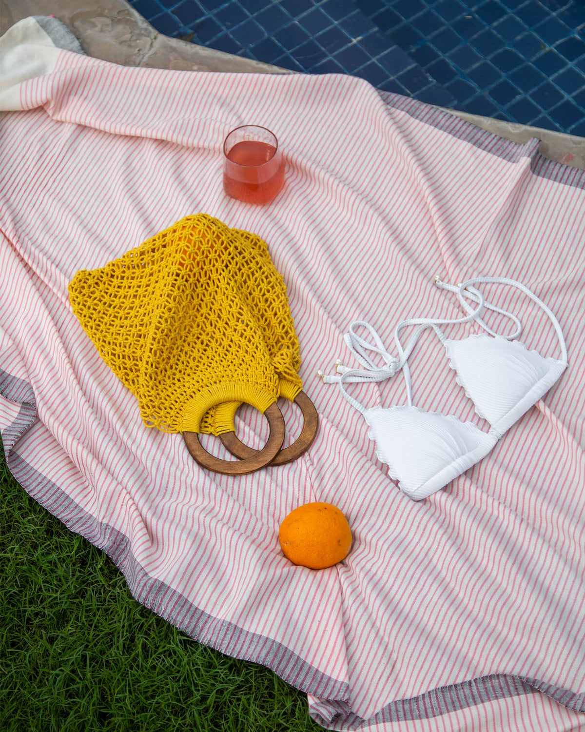 Yellow Mandovi Bag with wooden ring handles, styled in a flat lay.