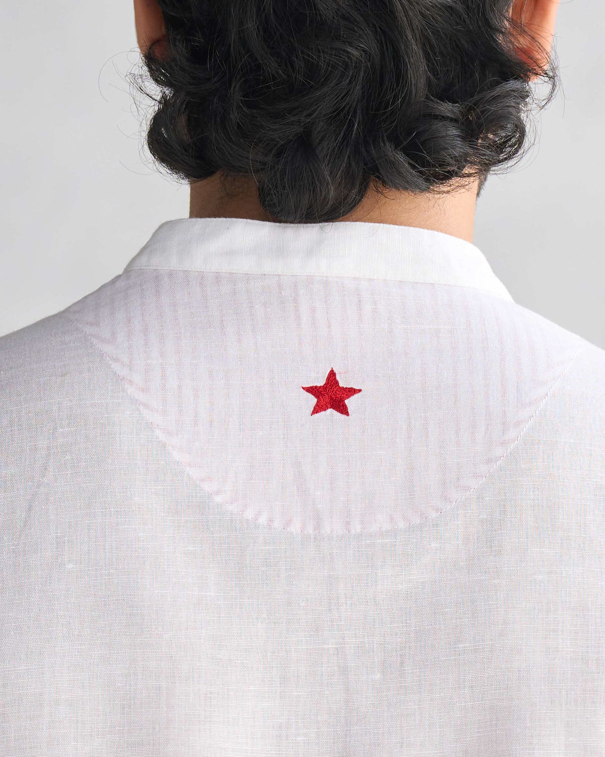 Close-up of the red star embroidery on a white Chandni Chowk kurta.