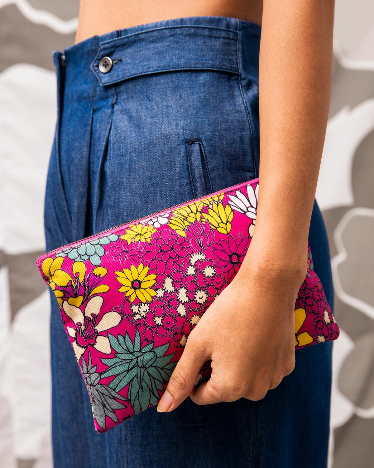 Person holding Cascade Midi Pouch in pink floral print.