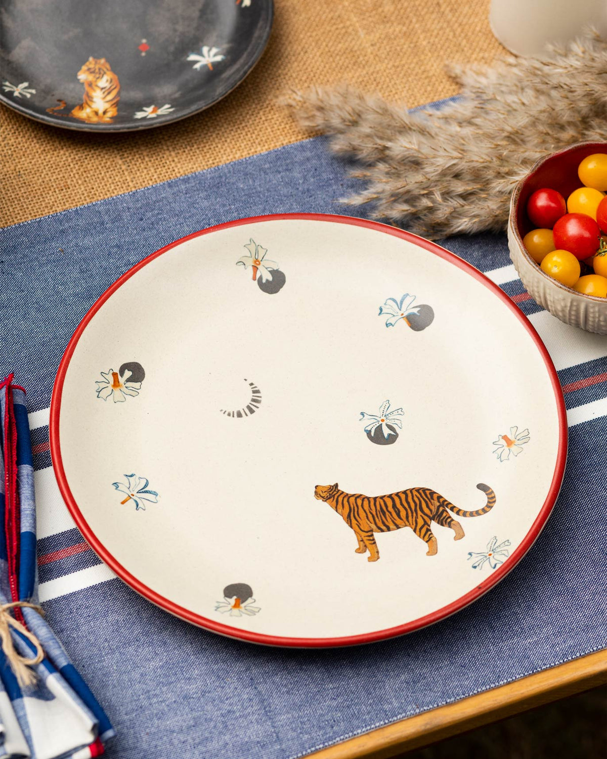 Jheel Dinner Plate with a red rim and an orange and black tiger.