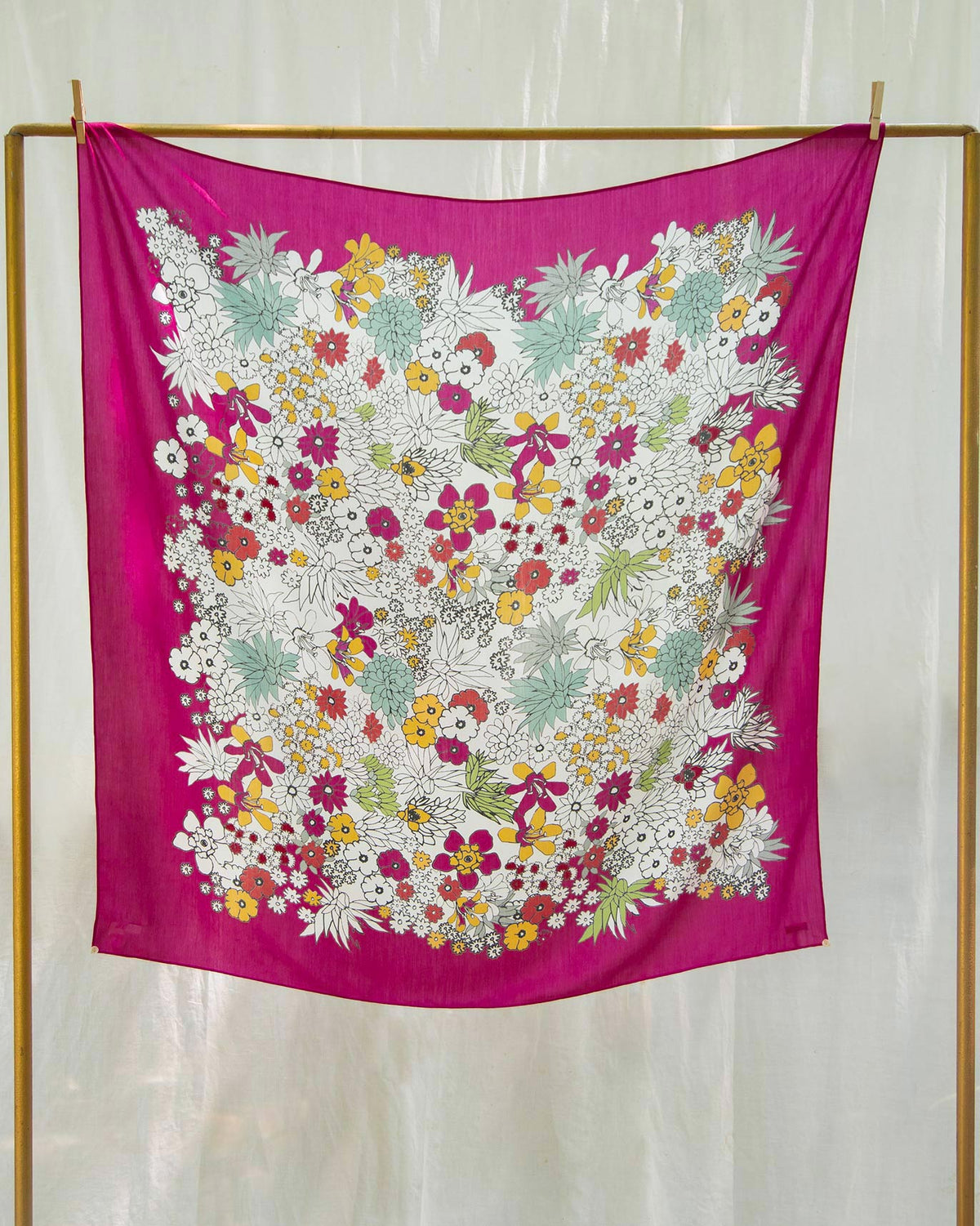 Cascade Scarf as a square with white, yellow and pink flowers on a magenta border.