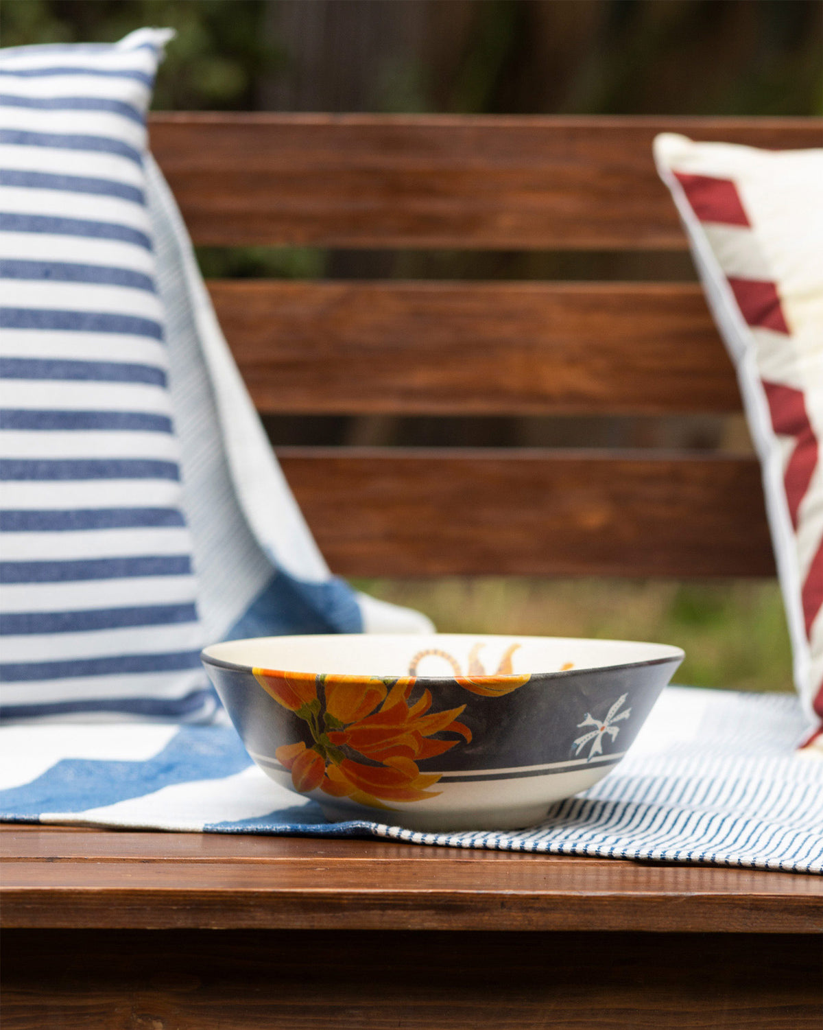 Charcoal Nadi curry bowl with a cream interior and large orange flower print.