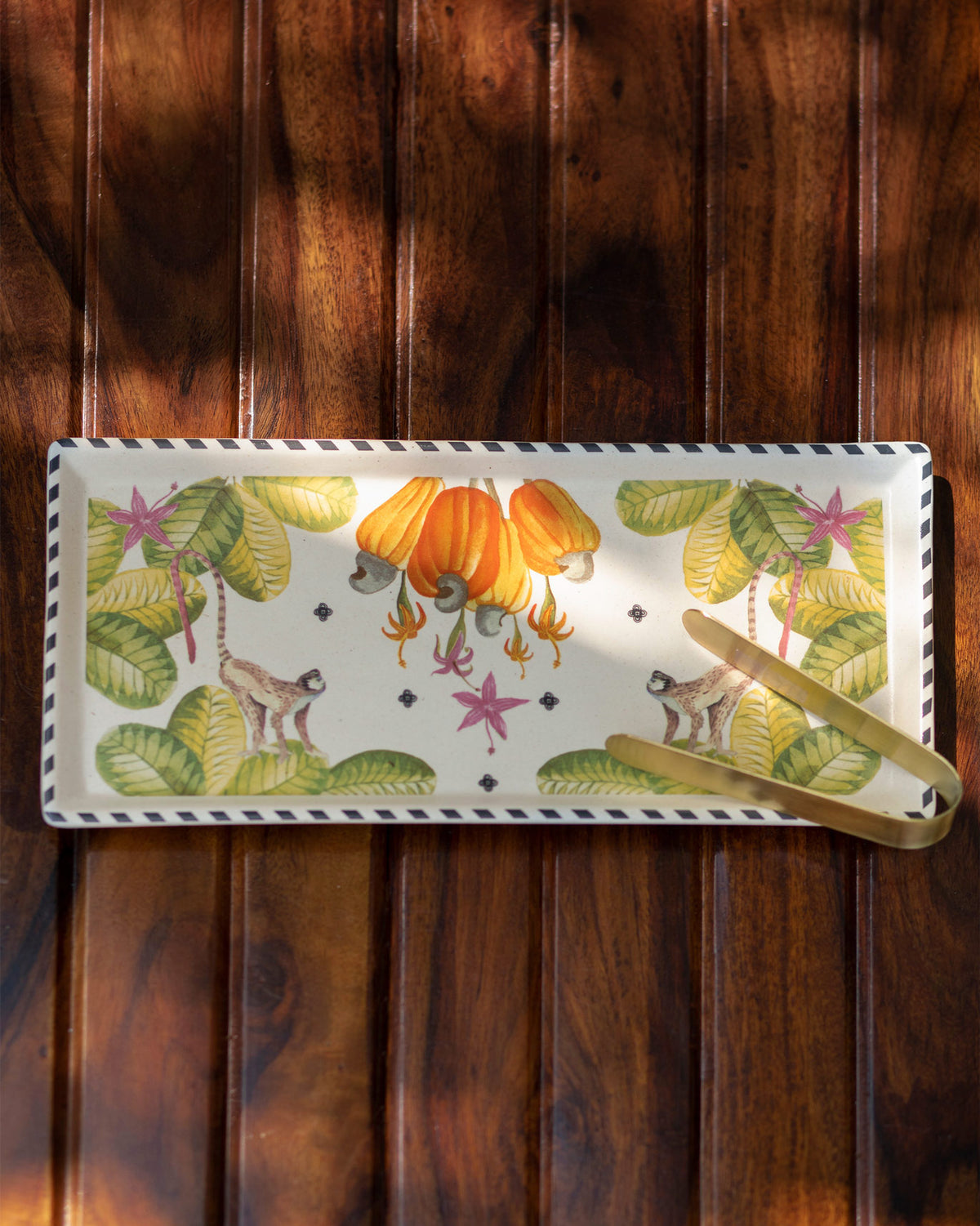 Mahi Cookie Tray & Tong with monkey and fruit motifs and gold tongs.
