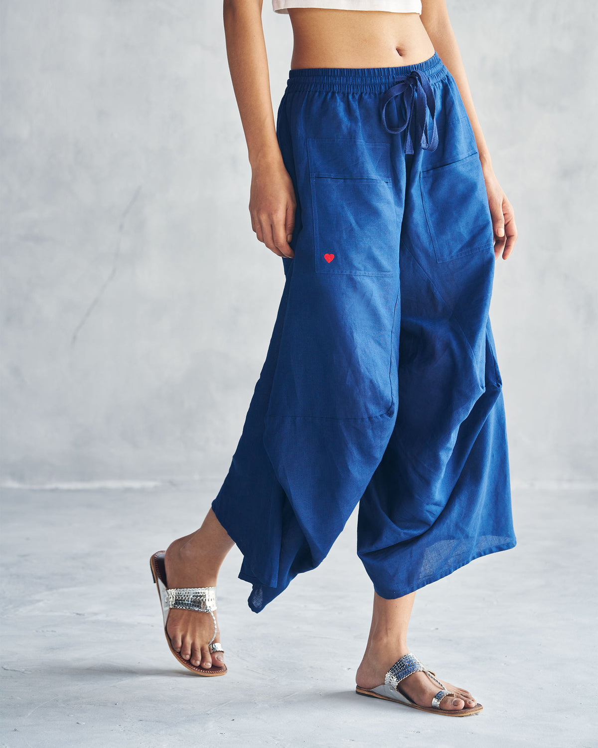 Navy Yoka Trousers with a red heart on the pocket.